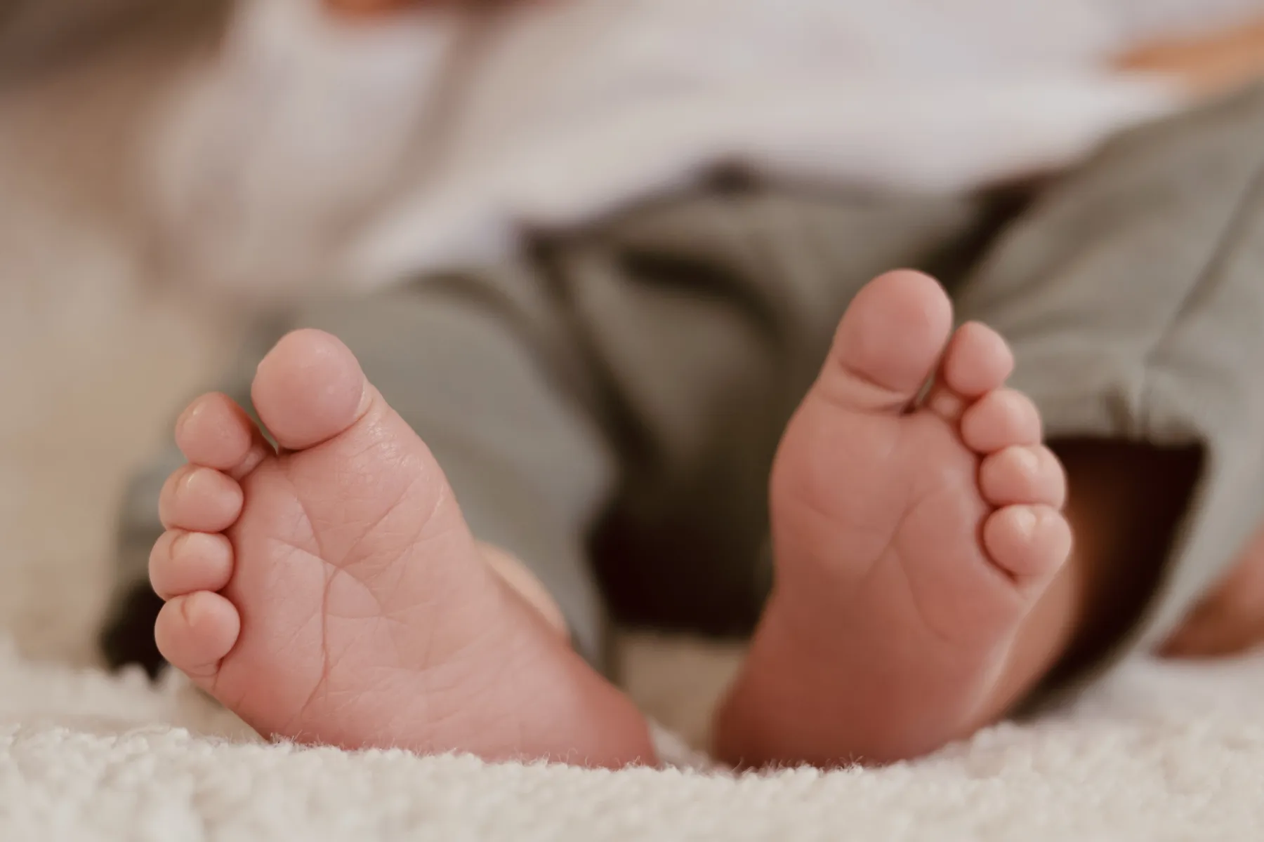 Les petits pieds d'un nouveau-né sur un plaid